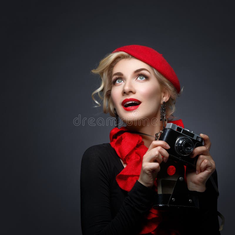 Funny girl in red casual shirt and beret making superhero pose while  looking at camera - a Royalty Free Stock Photo from Photocase
