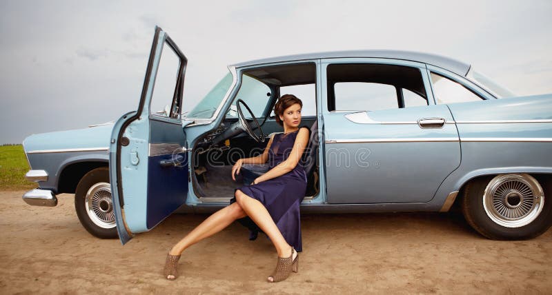 Beautiful lady sitting in a retro car