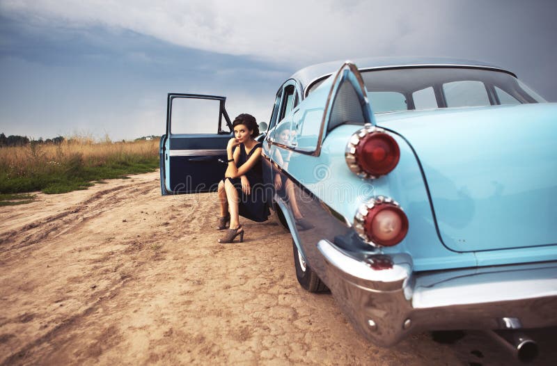 Beautiful lady sitting in a retro car