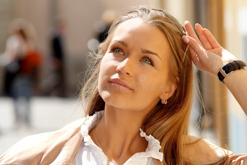 Beautiful lady in a sunny cityscape