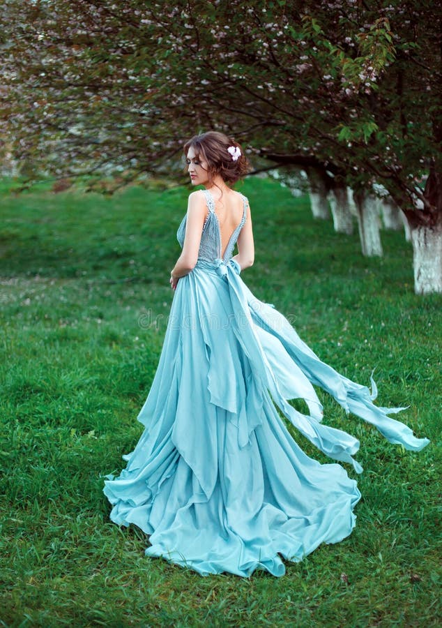 Beautiful lady walking in the garden in spring