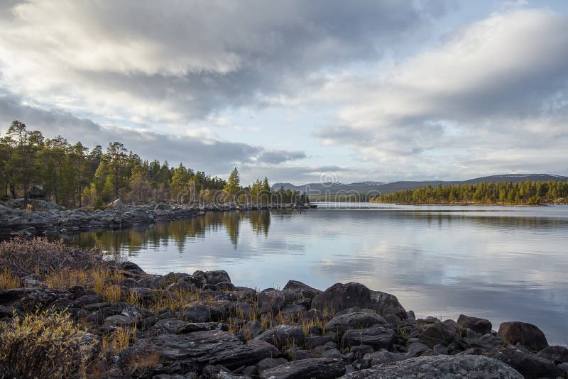 A beautiful lake landscape in Femundsmarka National Park in Norway. Lake with a distant mountains in background. Nature, october.