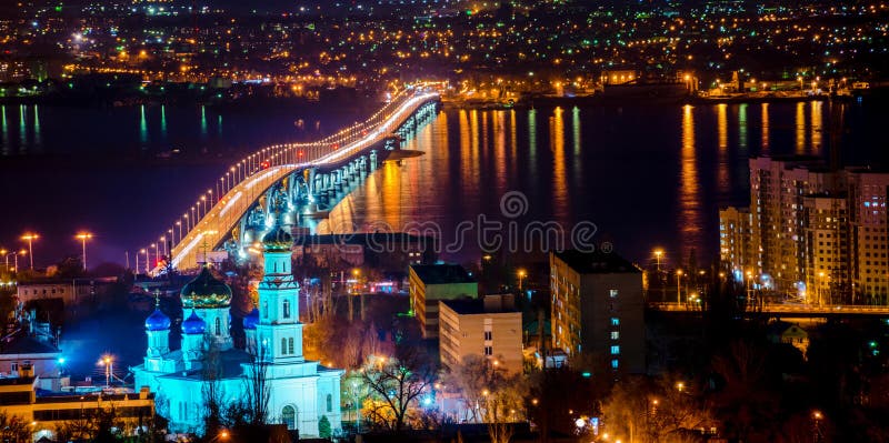 beautiful landscape of evening city Saratov with church and bridge through the Volga River, Russia, panorama