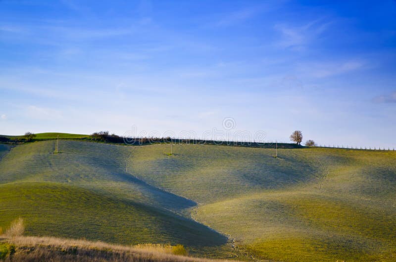 Beautiful landscape of green rolling hills under a clear blue sky stock photo Beautiful landscape of green rolling hills under a clear blue sky stock photo