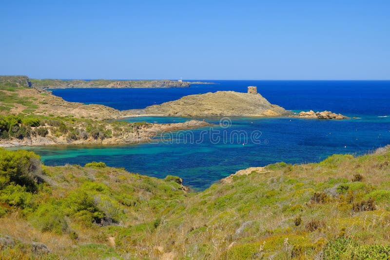 View on the light house Cape Favaritx and the old watch tower Es Colomar in Es Grau on Menorca