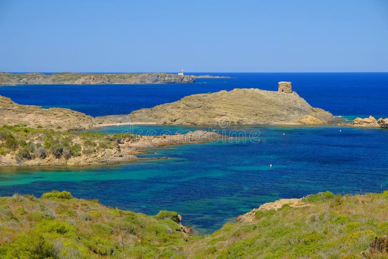 View on the light house Cape Favaritx and the old watch tower Es Colomar in Es Grau on Menorca