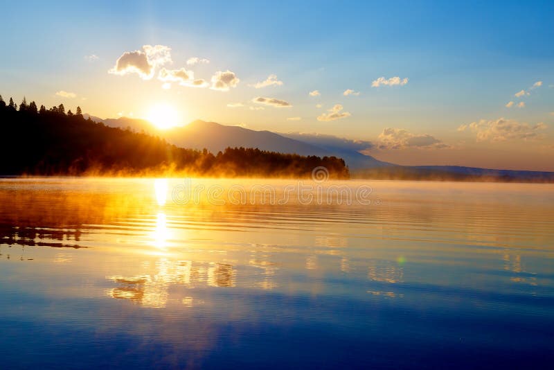 Beautiful landscape with mountains and lake at dawn in golden blue and orange tones. Slovakia, Central Europe, region. Liptov royalty free stock images Beautiful landscape with mountains and lake at dawn in golden blue and orange tones. Slovakia, Central Europe, region. Liptov royalty free stock images