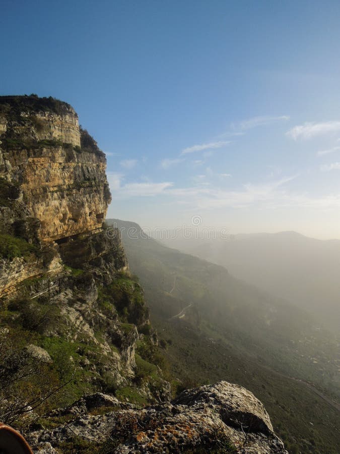 Beautiful landscape in Niha , the lebanese village with green grass and yellow trees and bright blue magical sky