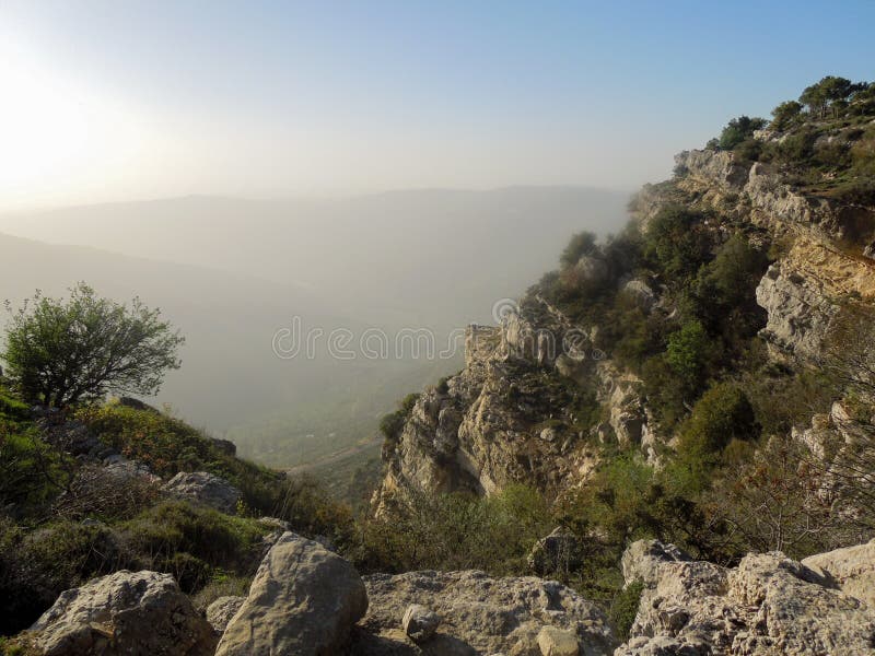 Beautiful landscape in Niha , the lebanese village with green grass and yellow trees and bright blue magical sky