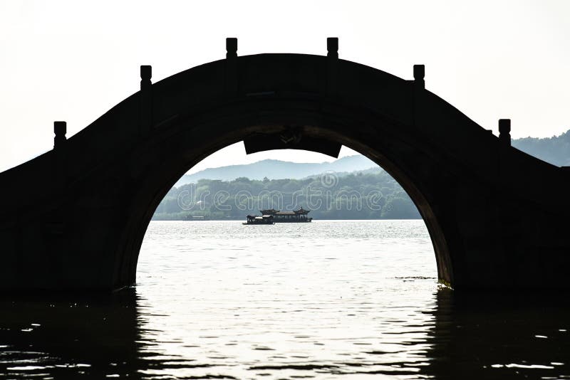 The beautiful of landscape scenery of Xihu West Lake, Sightseeing boat ,silhouette bridge and pavilion in Hangzhou CHINA
