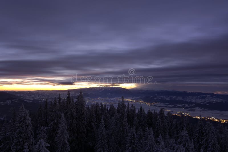 Beautiful landscape snow mountains at night on blue cloud and star background. Piatra Craiului mountains, view from Postavaru. Mountains royalty free stock image Beautiful landscape snow mountains at night on blue cloud and star background. Piatra Craiului mountains, view from Postavaru. Mountains royalty free stock image