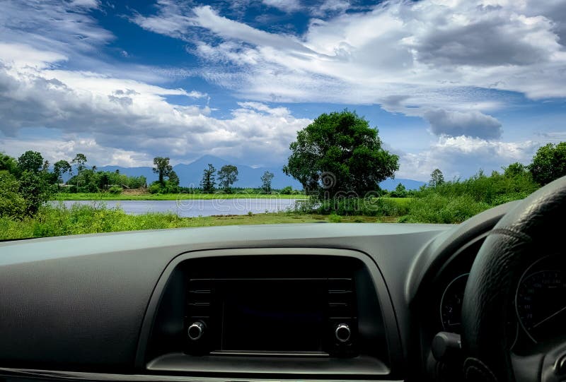 Beautiful landscape view from inside car. Steering wheel and dashboard of car interior. Road trip travel with scenic view stock photos Beautiful landscape view from inside car. Steering wheel and dashboard of car interior. Road trip travel with scenic view stock photos