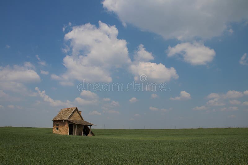 Beautiful landscape in Vojvodina Serbia, blue sky and green grass with small rustic house stock image Beautiful landscape in Vojvodina Serbia, blue sky and green grass with small rustic house stock image