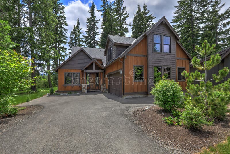 Beautiful large American Northwest home  exterior with brown wood in the forest