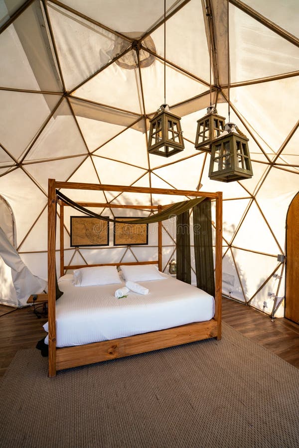 Beautiful Large Rustic Tent with Queen Size Bed in Nature Stock Photo