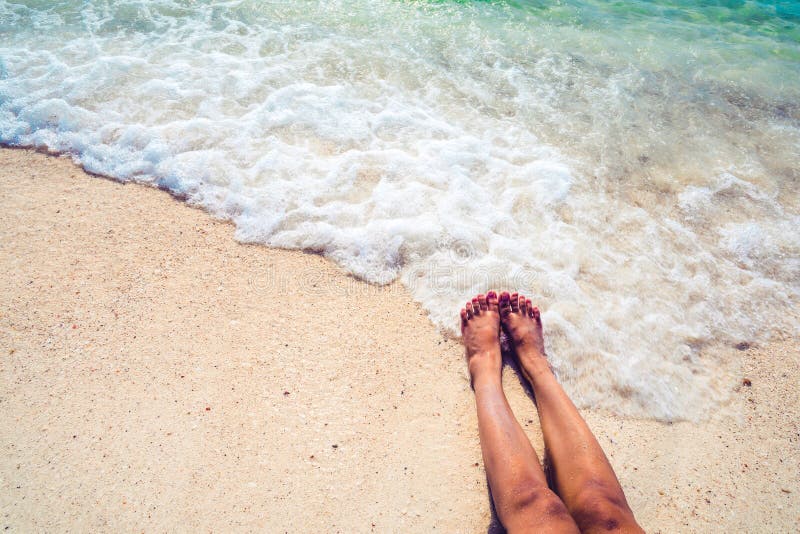 Beautiful Leg Of Women Tan Relax On Sandy Tropical Beach Stock Image