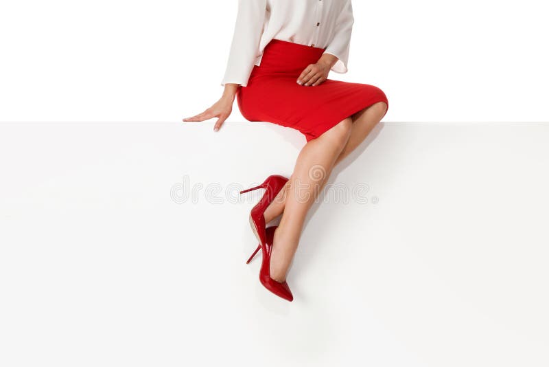 Legs woman wearing high heels shoes sitting on bench.