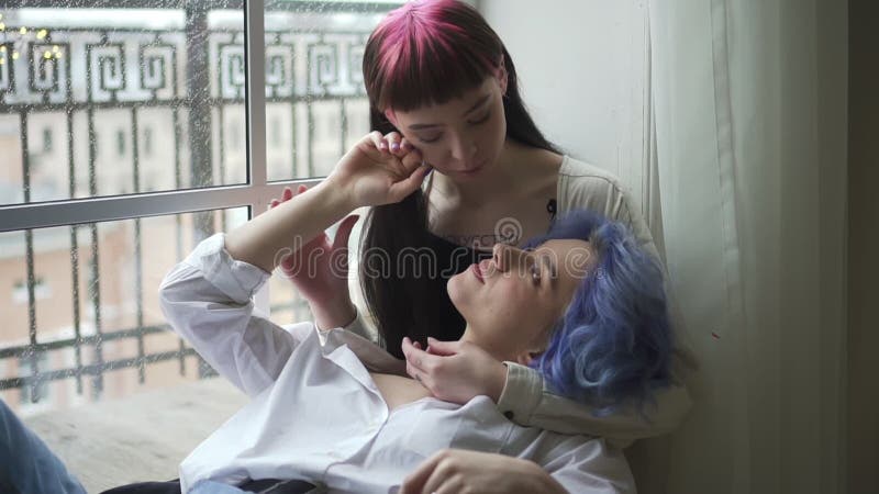 Beautiful Lesbian Women are Touching and Kissing while Sitting by Window in Apartment. Spbd Stock Footage - Video of casual, moments: 181311162