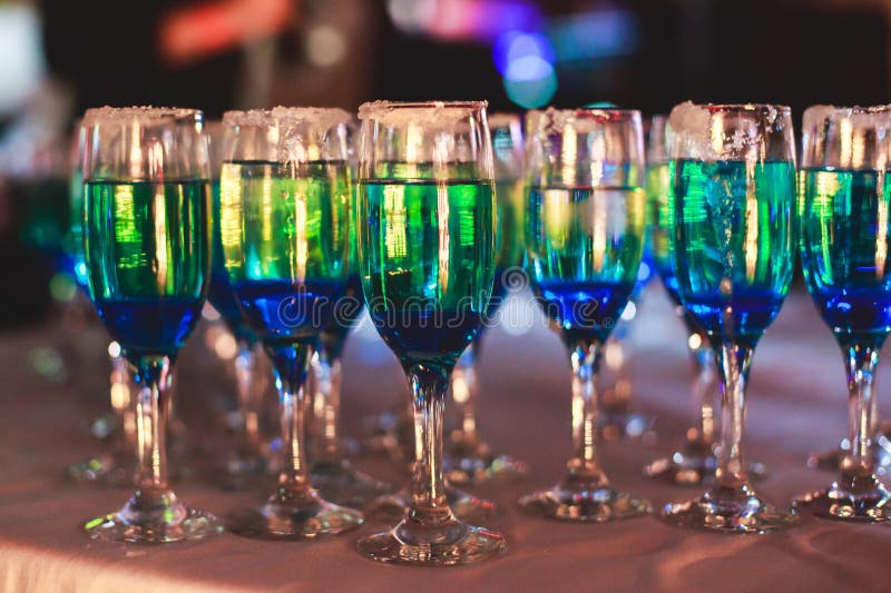 Beautiful line of different colored alcohol cocktails with smoke on a Christmas party, tequila, martini, vodka, and others on part stock photos Beautiful line of different colored alcohol cocktails with smoke on a Christmas party, tequila, martini, vodka, and others on part stock photos