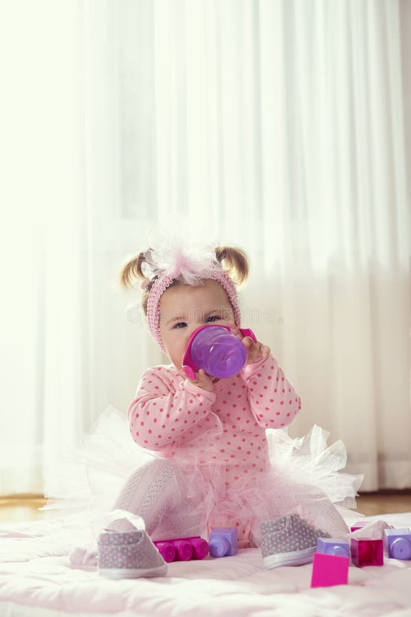 Baby girl drinking water from a bottle royalty free stock image Baby girl drinking water from a bottle royalty free stock image