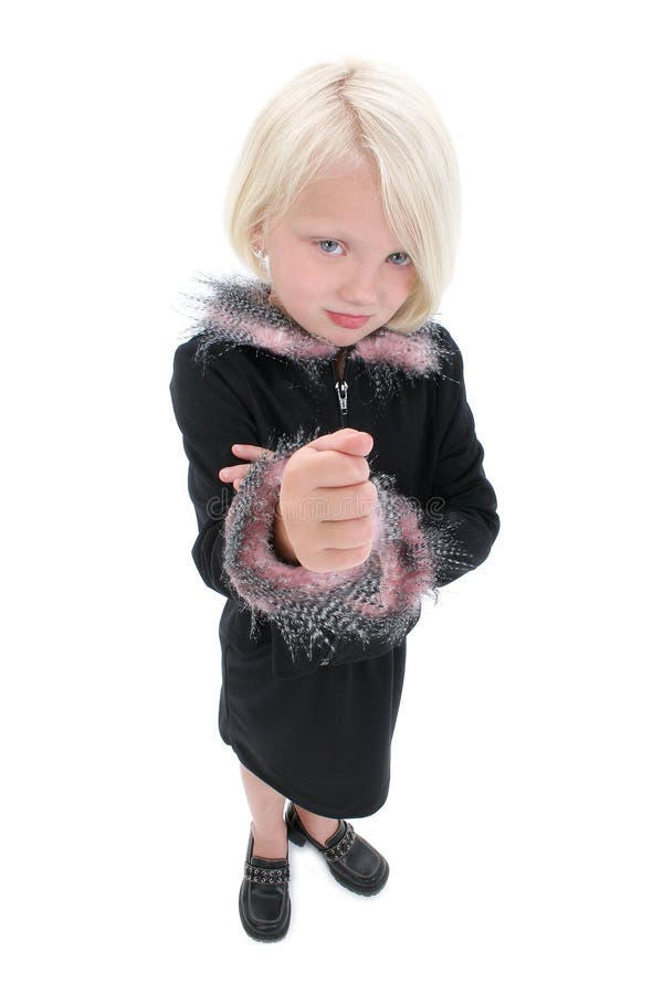 Beautiful Little Girl With Angry Face and Fist Up Wearing Black Suit With Pink Feathers. Shot in studio over white.