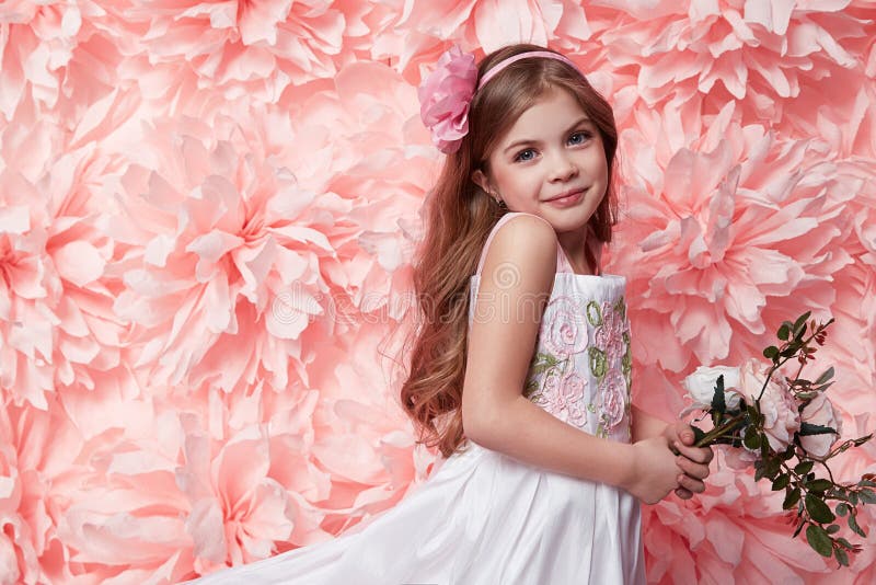 Beautiful little girl in cute dress with flower