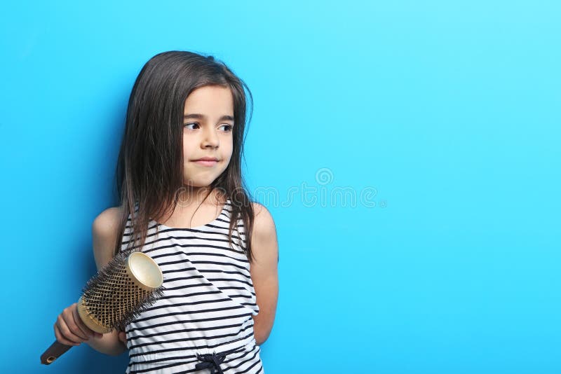 Little girl with hair comb stock image Little girl with hair comb stock image