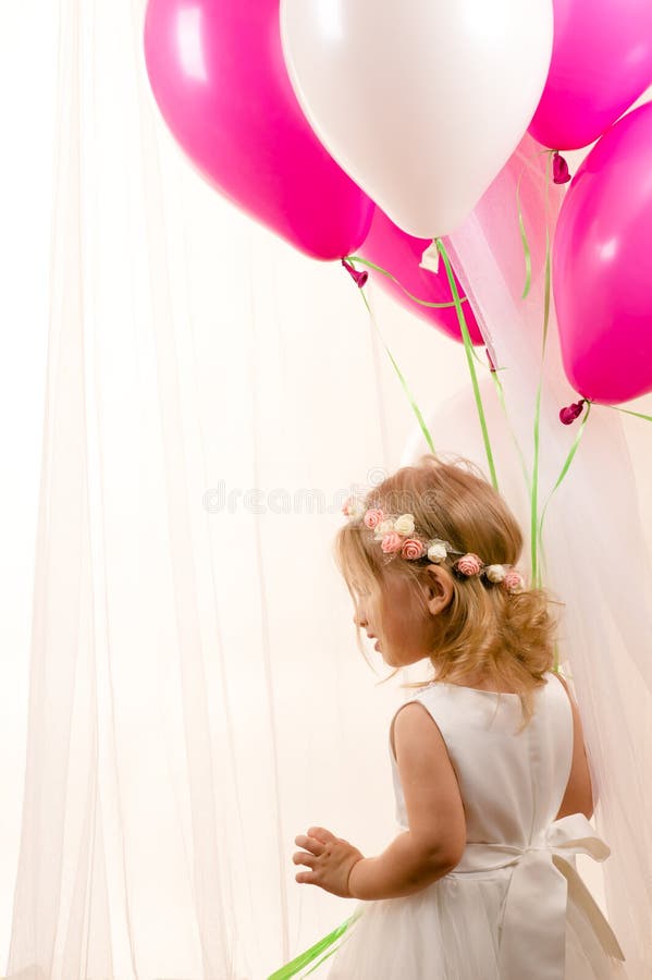 Beautiful little girl holding balloons at birthday party stock photos Beautiful little girl holding balloons at birthday party stock photos