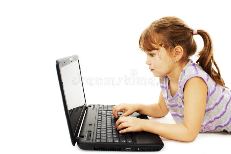 Beautiful little girl lying on floor with a laptop