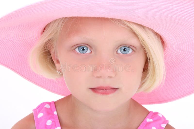 Beautiful Little Girl In Pink Swim Suit And Large Hat. Close-up with serious expression. Shot in studio over white with the Canon 20D.