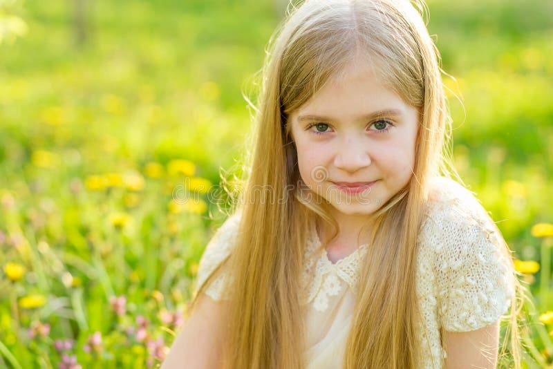 A Beautiful Little Girl Runs through a Flowering Garden in the S Stock ...