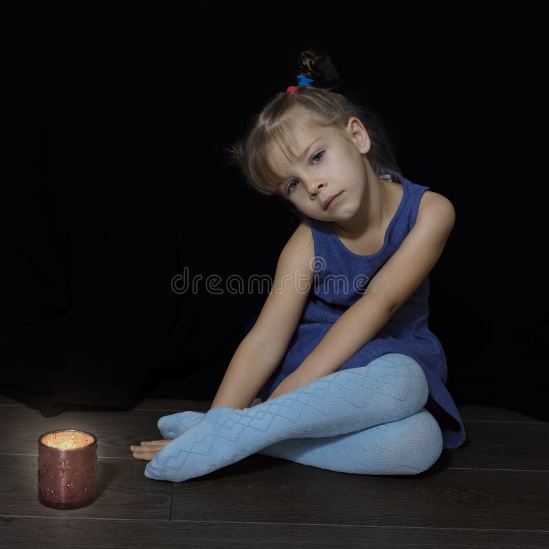 Beautiful Little Girl is Sad by the Lighted Candle Stock Photo - Image ...