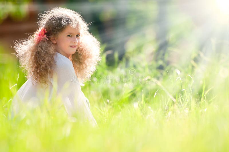 Beautiful little girl smiling and walking in field