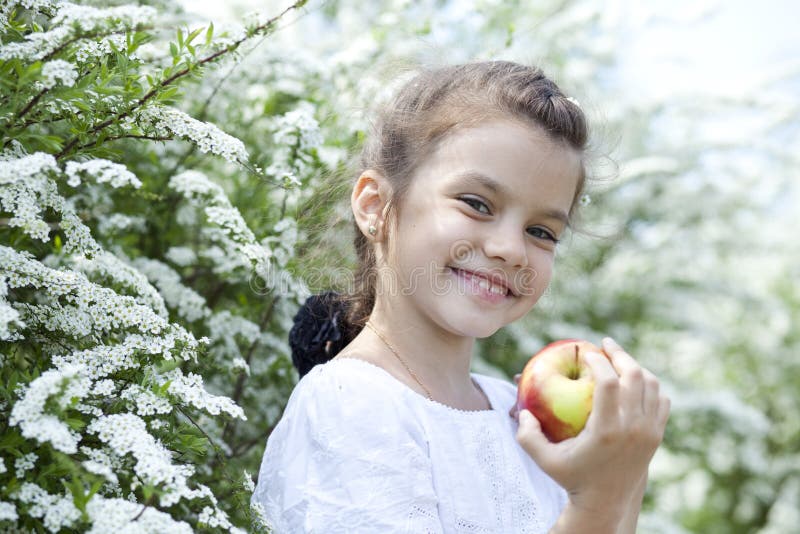 beautiful little girl in spring blossom