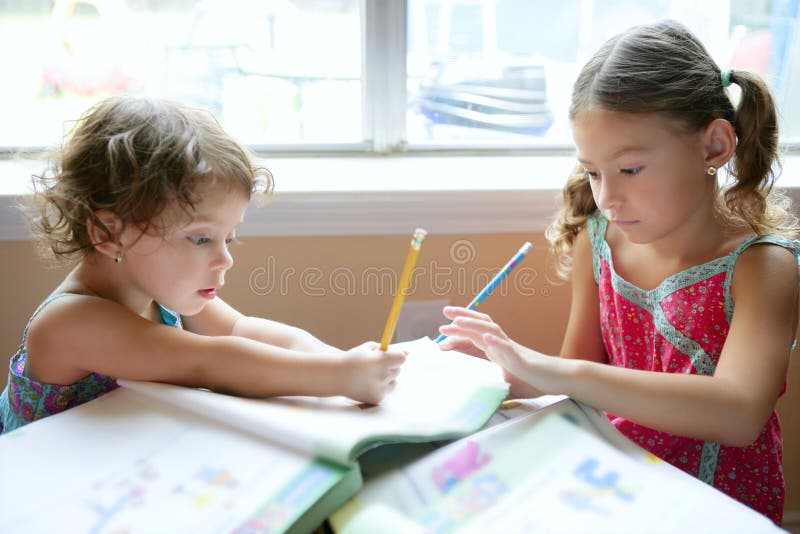 Beautiful little girls, homework at home royalty free stock photography Beautiful little girls, homework at home royalty free stock photography