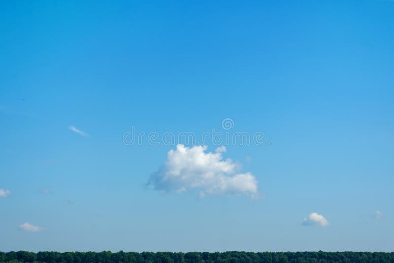 Beautiful, lonely cloud, in the blue sky, over the horizon. Copy space. Nature stock photos