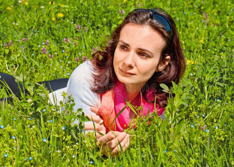 Beautiful lonely woman waiting in the grass