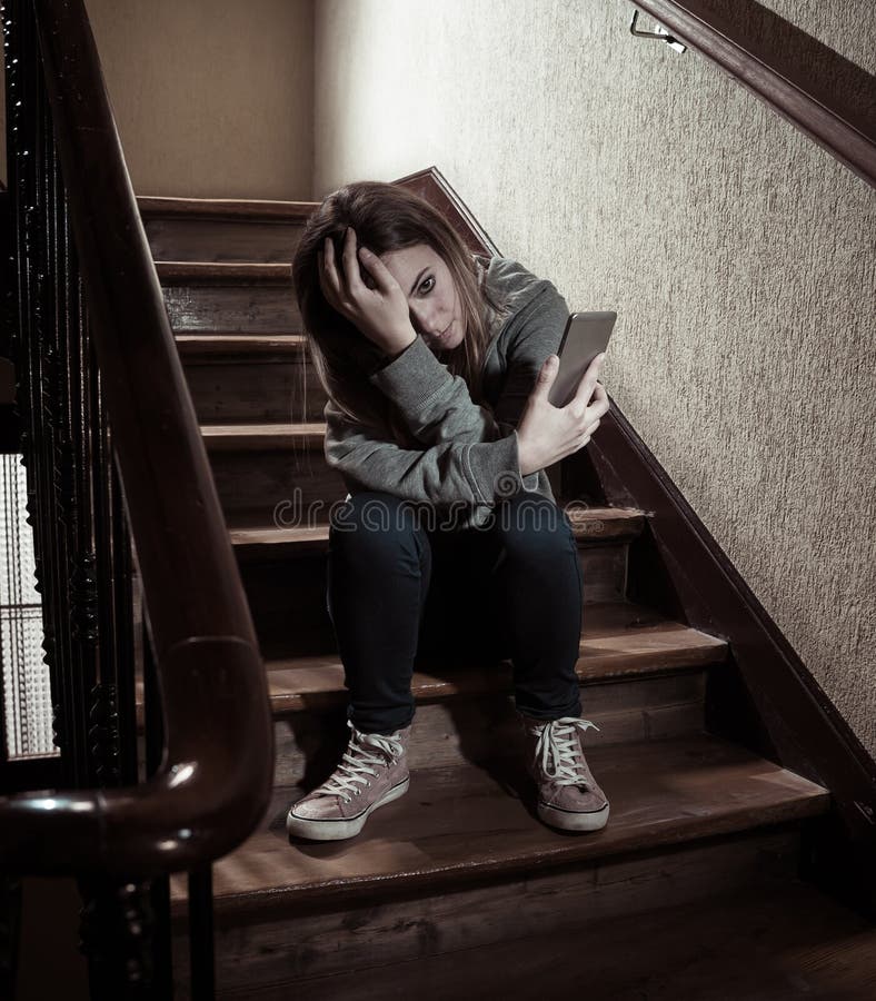 Beautiful lonely young girl depressed and worried suffering from bullying and harassment at school stock photo Beautiful lonely young girl depressed and worried suffering from bullying and harassment at school stock photo