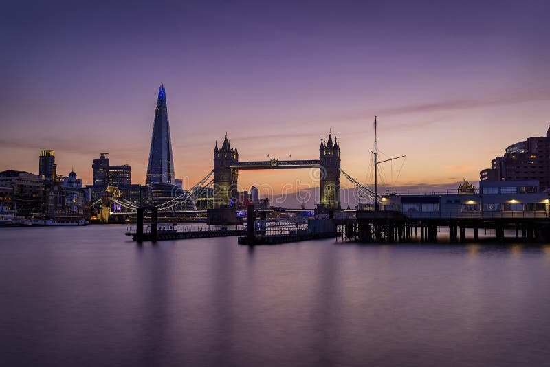 Beautiful long exposure view to the Thames river and skyline of London with Tower Bridge during sunset time, United Kingdom