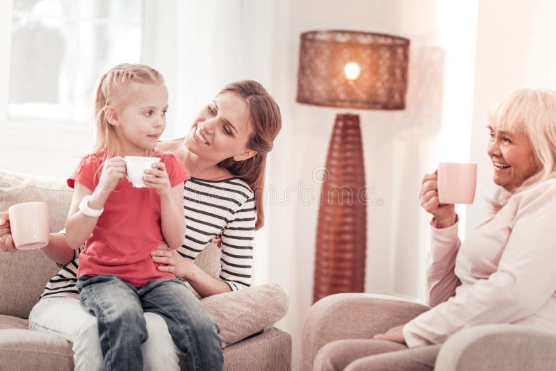 Beautiful long-haired mother feeling gorgeous with her daughter royalty free stock image Beautiful long-haired mother feeling gorgeous with her daughter royalty free stock image