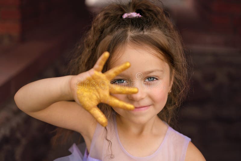 A Beautiful Lovely Girl with Clear Blue Eyes Shows Five Fingers on Her