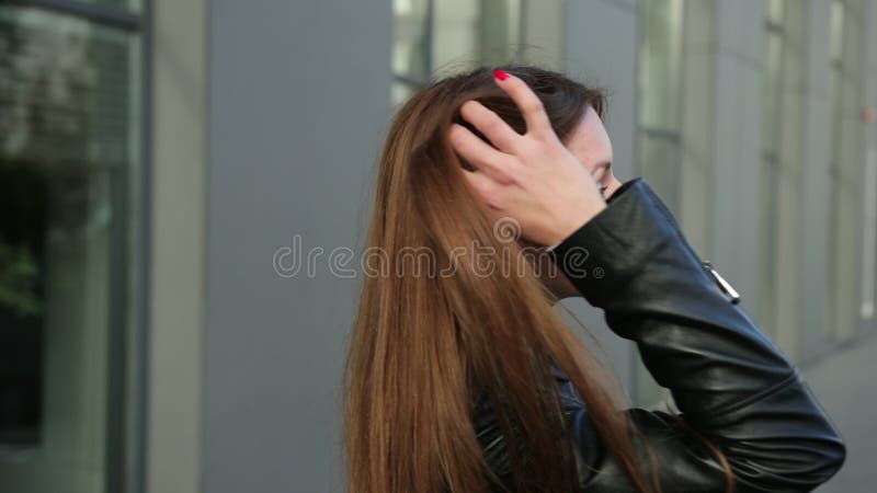 Beautiful lovely happy female with brown hair smiles at camera, a half turn