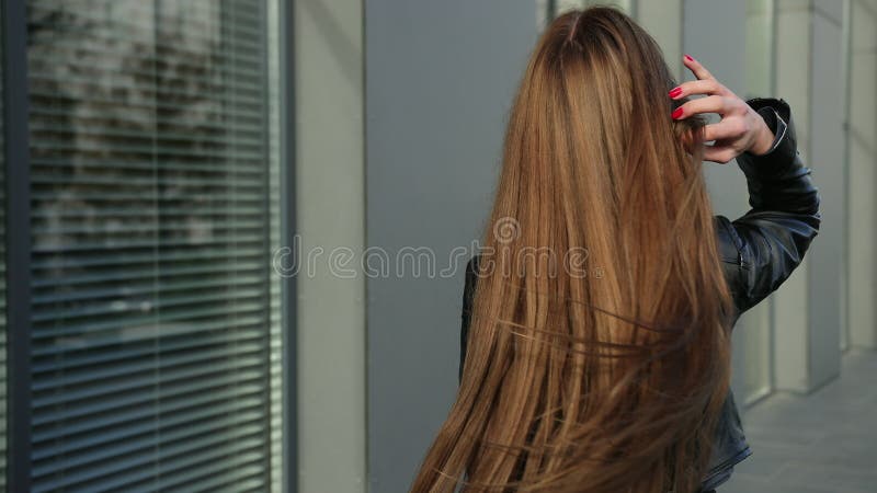 Beautiful lovely happy female with brown hair smiles at camera, a half turn