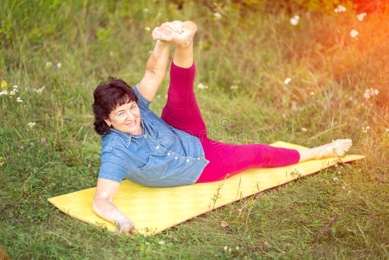 Beautiful Mature Women with Doing Yoga in Forest Park Stock Image ...