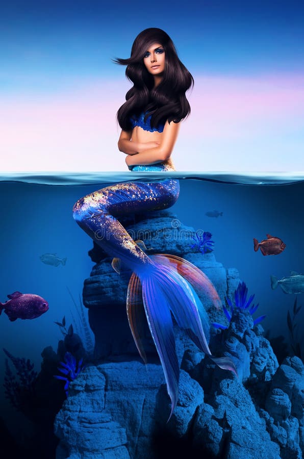 Beautiful mermaid sitting half in water royalty free stock photo Beautiful mermaid sitting half in water royalty free stock photo