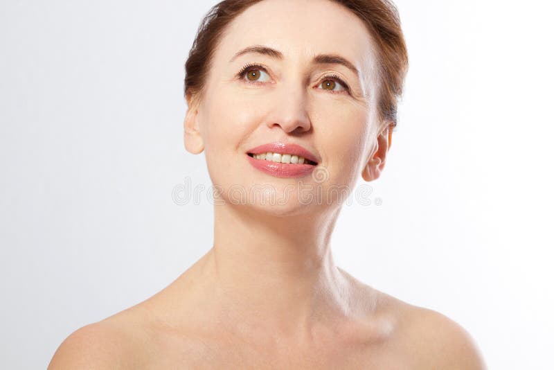 Beautiful middle age woman face close up isolated on white. Collagen and face injections. Plastic surgery. Anti aging concept.