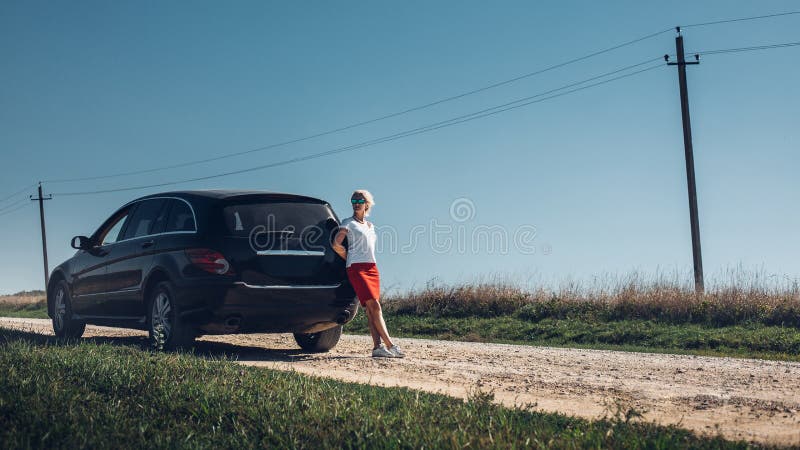 Beautiful middle aged woman enjoying road trip. Successful woman freedom holidays concept royalty free stock photos Beautiful middle aged woman enjoying road trip. Successful woman freedom holidays concept royalty free stock photos