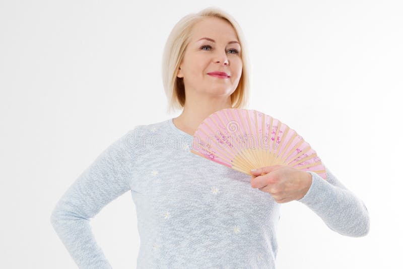 Beautiful middle aged woman with menopause blowing by fan. Hormone replacement therapy and mature woman healthcare. Mid age happy