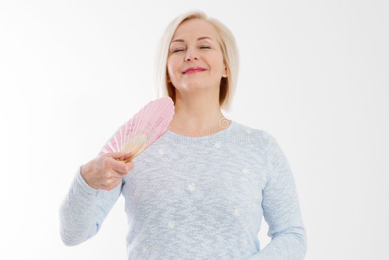 Beautiful middle aged woman with menopause blowing by fan. Hormone replacement therapy and mature woman healthcare. Mid age happy woman lifestyle. Senior woman isolated on white background