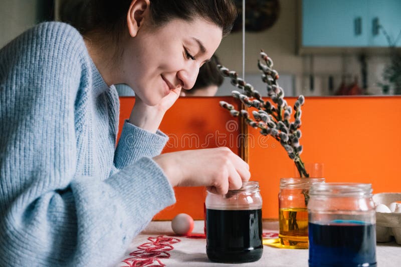 Beautiful millennial woman dying Easter eggs stock photos Beautiful millennial woman dying Easter eggs stock photos